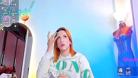 A sexy redhead is playing with her sexy lingerie and stockings